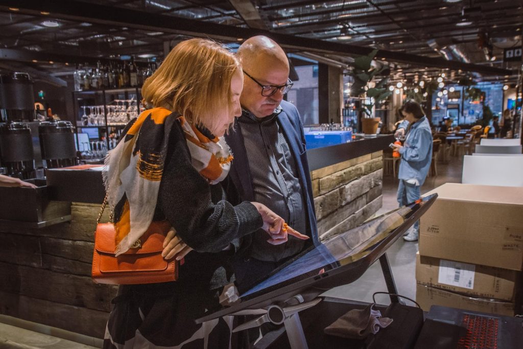 Familiarising with the background materials and received public comments about Teollisuuskatu planning site over touchscreen at 2nd Helsinki pop-up, photo Meeri Lehto