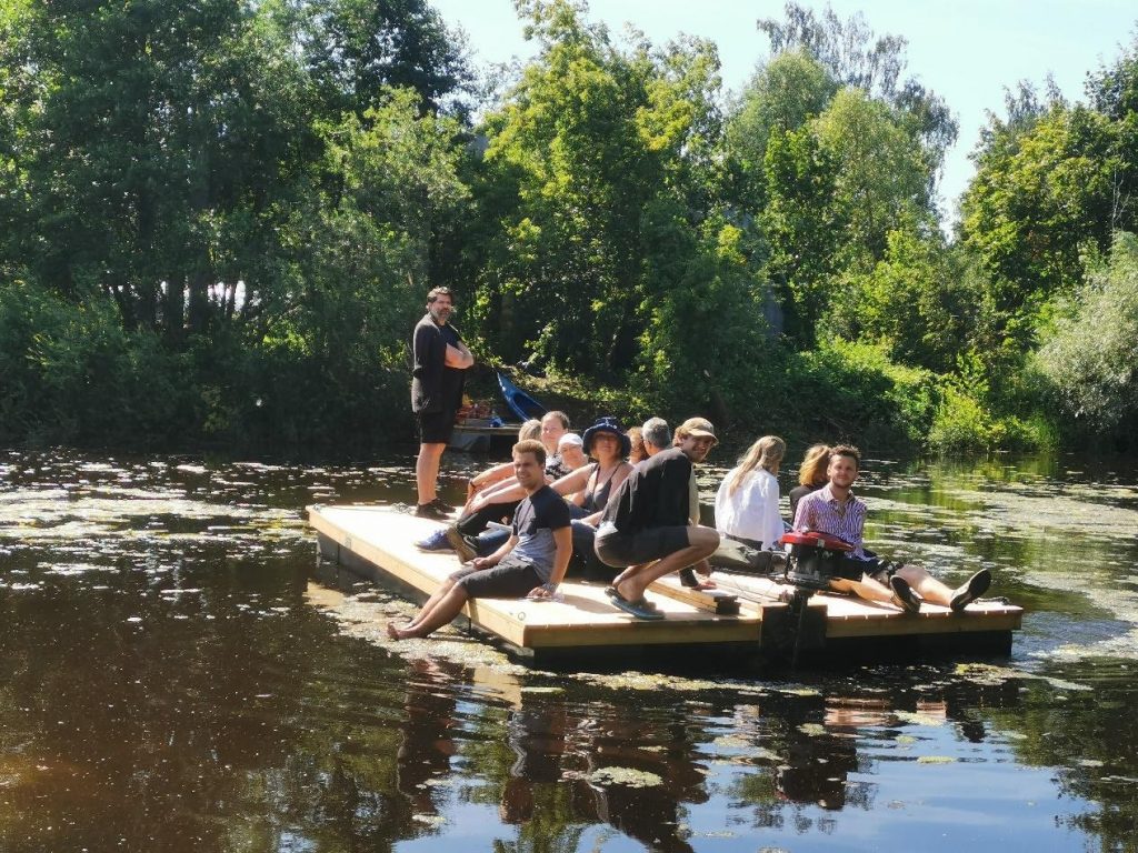 Augmented Urbans' Riga Team and stakeholders sailing on a float to Kruminsala island